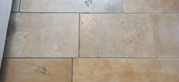 cottage-travertine-grout-before-cleaning-2 Travertine floor in a cottage with dirty grey grout before cleaning