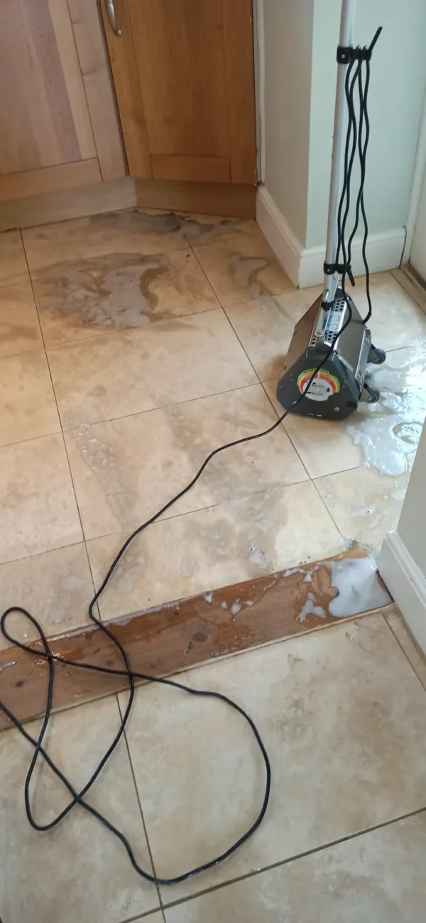 kitchen-floor-tile-cleaning-machine-scrub Machine scrubbing kitchen floor tiles during a deep clean