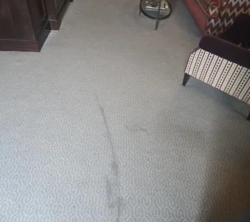 Red wine stains on a wool hotel carpet before professional cleaning