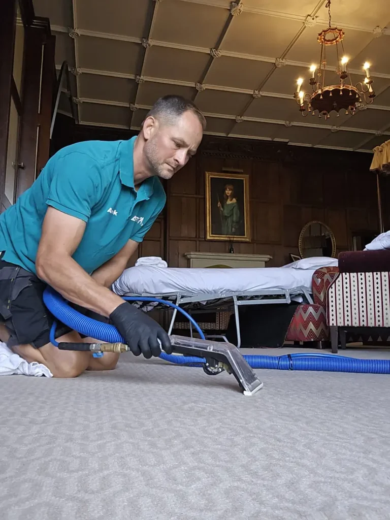 Spot cleaning a wool carpet in a historic hotel